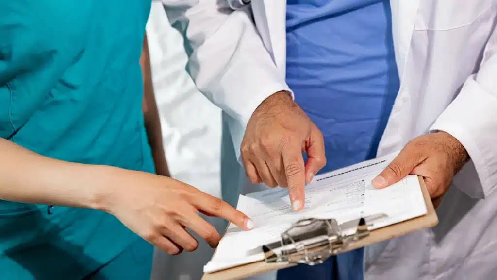 doctors pointing on a clipboard discussing about patient record