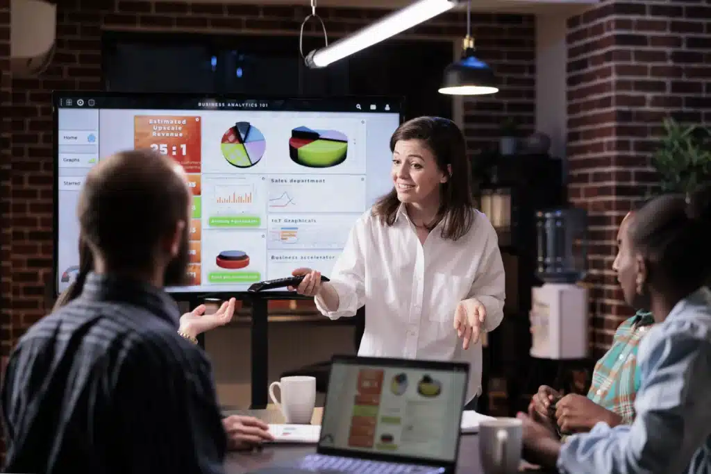 Marketing consultant presenting performance analytics and growth metrics to a business team to optimize marketing strategy